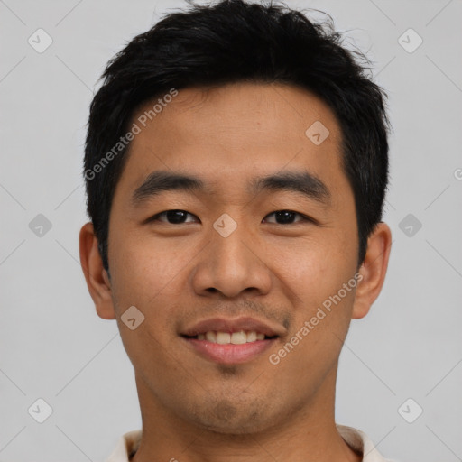 Joyful asian young-adult male with short  black hair and brown eyes