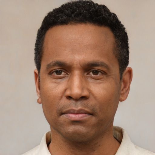 Neutral latino adult male with short  black hair and brown eyes
