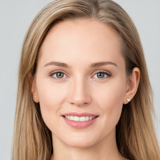 Joyful white young-adult female with long  brown hair and blue eyes