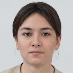 Neutral white young-adult female with short  brown hair and brown eyes