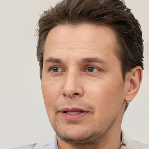 Joyful white adult male with short  brown hair and brown eyes