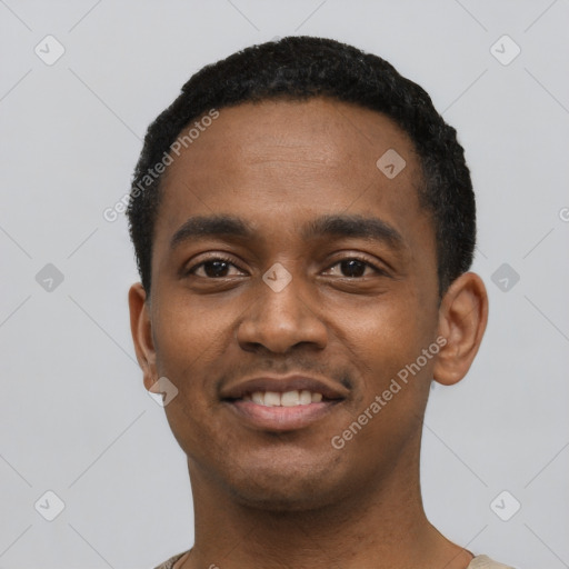 Joyful black young-adult male with short  black hair and brown eyes