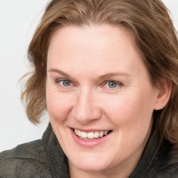 Joyful white adult female with medium  brown hair and blue eyes