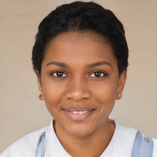 Joyful black young-adult female with short  black hair and brown eyes