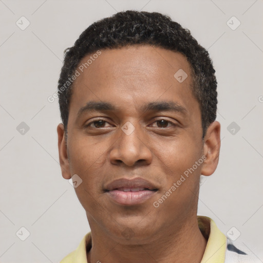 Joyful black young-adult male with short  black hair and brown eyes