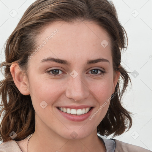 Joyful white young-adult female with medium  brown hair and blue eyes