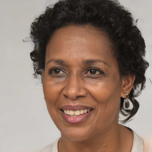 Joyful black adult female with medium  brown hair and brown eyes