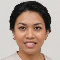 Joyful asian young-adult female with short  black hair and brown eyes