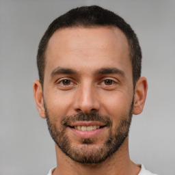 Joyful white young-adult male with short  brown hair and brown eyes