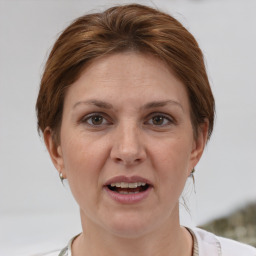 Joyful white adult female with short  brown hair and grey eyes