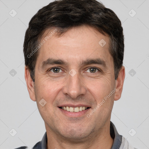 Joyful white adult male with short  brown hair and brown eyes