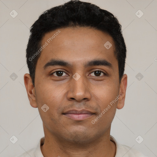 Joyful black young-adult male with short  black hair and brown eyes