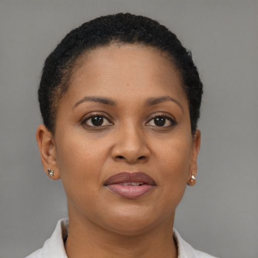 Joyful black young-adult female with short  brown hair and brown eyes