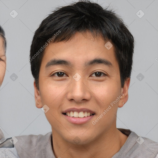 Joyful asian young-adult male with short  black hair and brown eyes