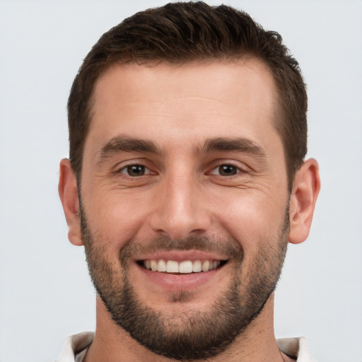 Joyful white young-adult male with short  brown hair and brown eyes