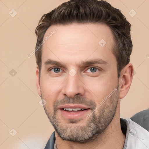 Joyful white adult male with short  brown hair and brown eyes