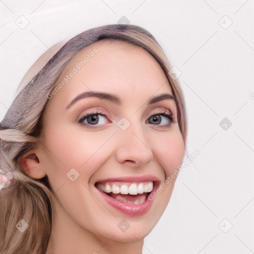 Joyful white young-adult female with long  brown hair and blue eyes