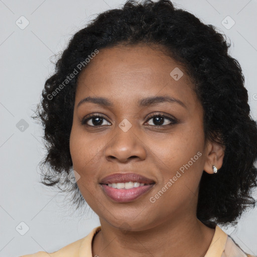 Joyful black young-adult female with long  black hair and brown eyes