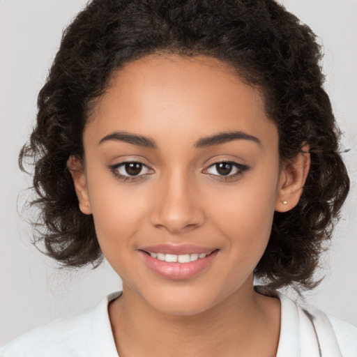 Joyful latino young-adult female with medium  brown hair and brown eyes