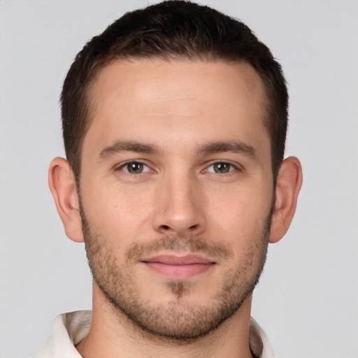 Joyful white young-adult male with short  brown hair and brown eyes