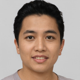 Joyful asian young-adult male with short  black hair and brown eyes