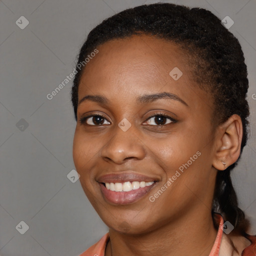 Joyful black young-adult female with short  black hair and brown eyes