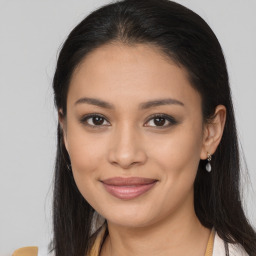 Joyful latino young-adult female with long  brown hair and brown eyes