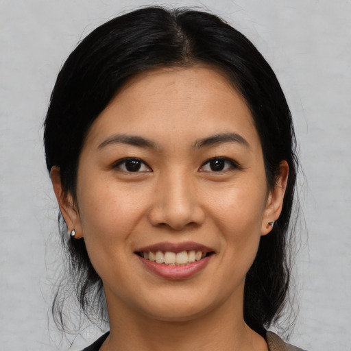 Joyful asian young-adult female with medium  brown hair and brown eyes