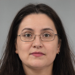 Joyful white adult female with long  brown hair and brown eyes