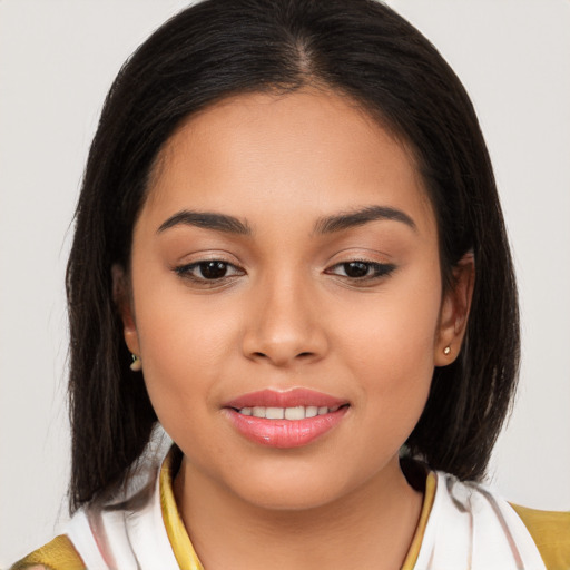 Joyful latino young-adult female with medium  brown hair and brown eyes