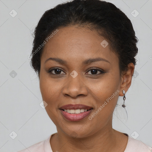 Joyful black adult female with short  brown hair and brown eyes