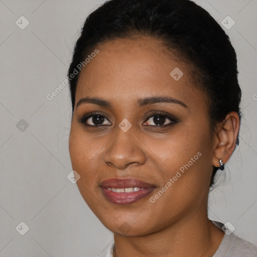 Joyful black young-adult female with short  brown hair and brown eyes