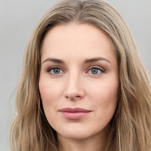 Joyful white young-adult female with long  brown hair and green eyes