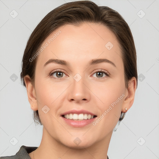 Joyful white young-adult female with short  brown hair and grey eyes