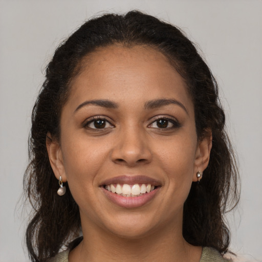 Joyful latino young-adult female with medium  brown hair and brown eyes