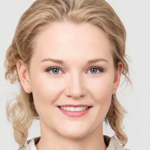 Joyful white young-adult female with medium  brown hair and blue eyes