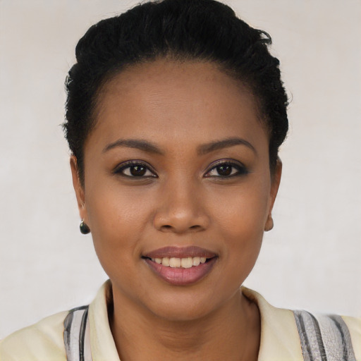 Joyful latino young-adult female with short  black hair and brown eyes