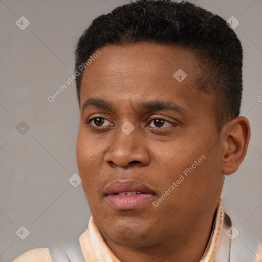Joyful black young-adult male with short  brown hair and brown eyes