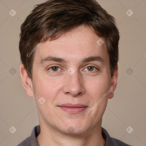 Joyful white adult male with short  brown hair and grey eyes