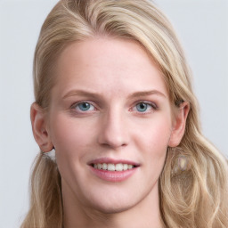 Joyful white young-adult female with long  brown hair and blue eyes
