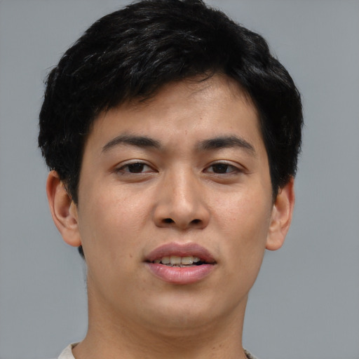 Joyful asian young-adult male with short  brown hair and brown eyes