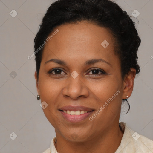 Joyful black young-adult female with short  brown hair and brown eyes