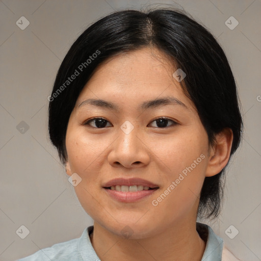 Joyful asian young-adult female with medium  black hair and brown eyes