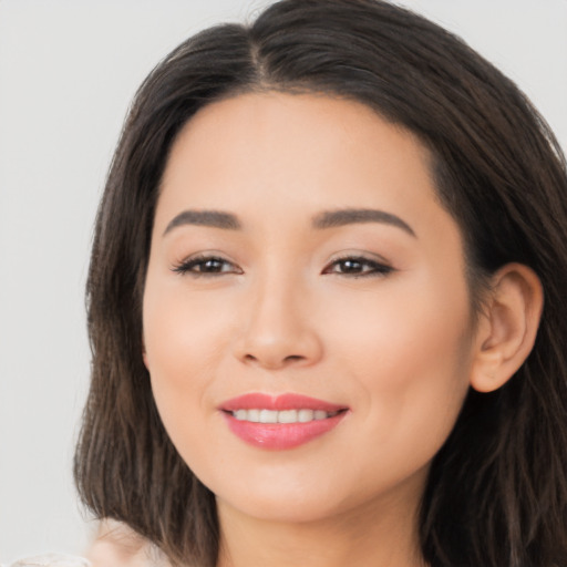 Joyful asian young-adult female with long  brown hair and brown eyes