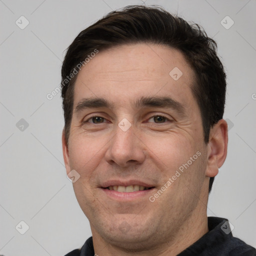 Joyful white adult male with short  brown hair and brown eyes