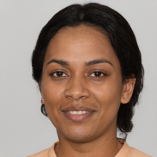 Joyful black adult female with medium  black hair and brown eyes