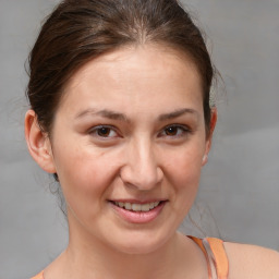 Joyful white adult female with medium  brown hair and brown eyes