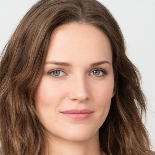 Joyful white young-adult female with long  brown hair and green eyes