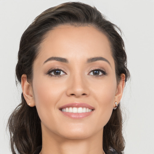 Joyful white young-adult female with long  brown hair and brown eyes