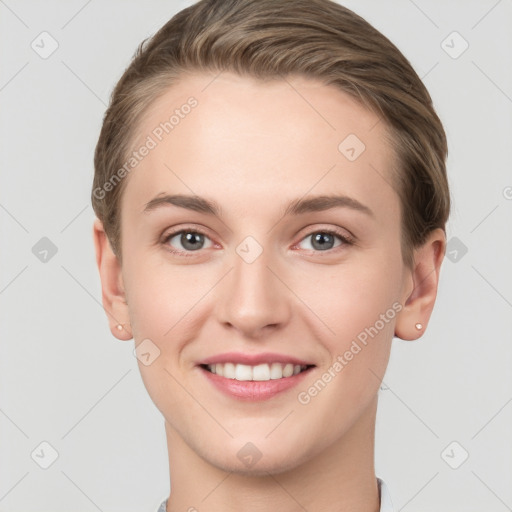 Joyful white young-adult female with short  brown hair and grey eyes